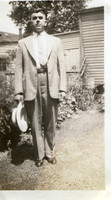 Holding his hat